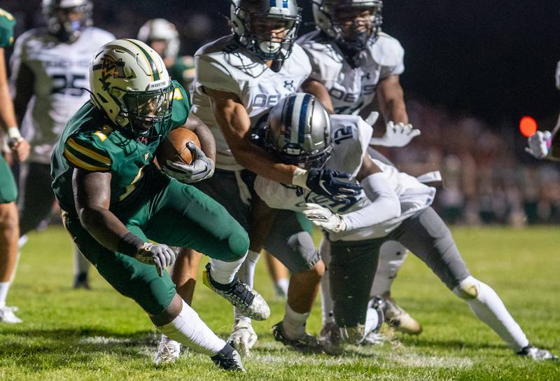 Waubonsie Valley's Chrisjan Simmons (1) dives into the end zone for a touchdown against Oswego East during a football game at Waubonsie Valley High School in Aurora on Friday, Aug. 25, 2023.