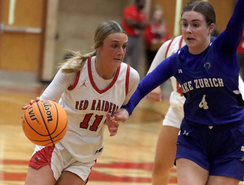 Huntley’s Anna Campanelli, left, drives on Lake Zurich’s Bella Hempfling in IHSA Class 4A Sectional girls basketball action on Tuesday, Feb. 25, 2025, at Huntley High School in Huntley.