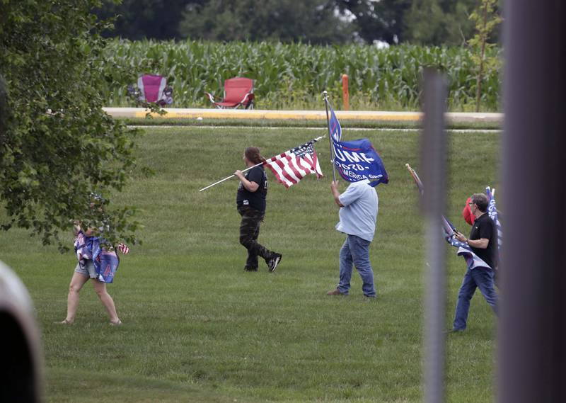 Trump supporters watch as helicopters arrive as President Joe Biden visits McHenry Community College Wednesday, July 7, 2021, in Crystal Lake.