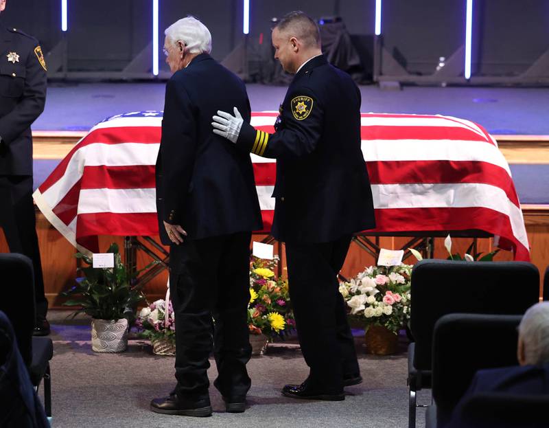 Current DeKalb County Sheriff Andy Sullivan (right) escorts former DeKalb County Sheriff Wilbur Scott, past the casket of Roger Scott, former sheriff and younger brother of Wilbur, during visitation Thursday, March 6, 2025, at Bethany Road Bible Church in DeKalb. Roger Scott, who was the county sheriff for more than 30 years, died on Feb. 23 at the age of 78.