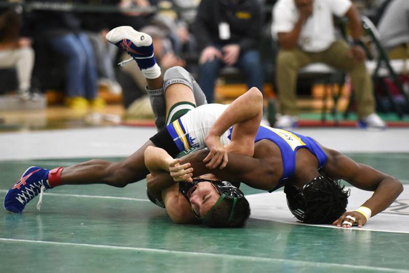 Coal City's Culan Lindemuth, left, tries avoiding a pin by De La Salle's Jeremiah Lawrence during the 120-pound championship match at the IHSA Class 1A Coal City Sectional Saturday, Feb. 15, 2025.