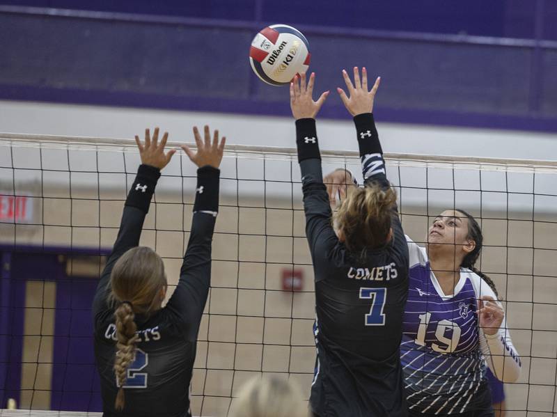 Dixon’s Hallie Williamson hammers a shot against Newman’s Sophia Ely (left) and Makenzie Duhon Monday, August 28, 2023 during a non-conference match-up in Dixon.