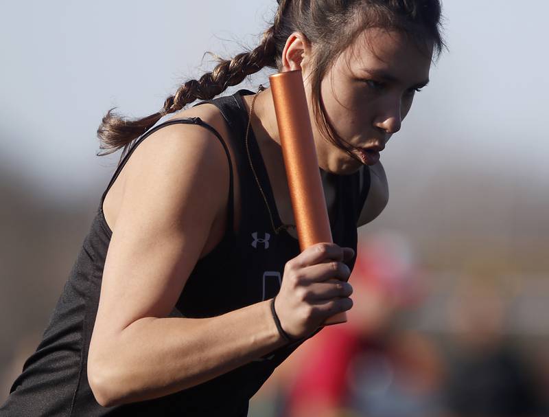 McHenry’s Angelina Bakewell blasts out of the blocks as she runs the first leg of the 4X100 relay Thursday, April 21, 2022, during the McHenry County Track and Field Meet at Richmond-Burton High School.