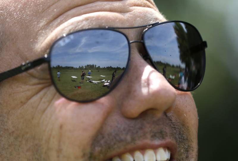 Mike Missak looks to the sky as radio-controlled planes are flown on Thursday, Aug. 8, 2024, with other members of the Chain-O-Lakes Eagles R/C Club near Hebron.