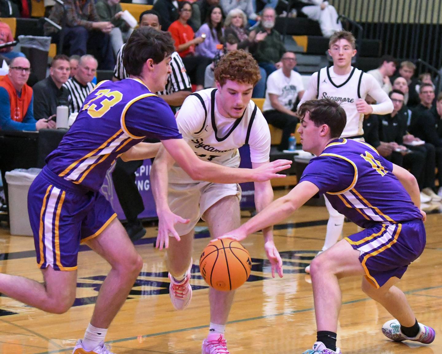 Mendota's Dane Doyle, left, defends Sycamore's Aidan Mesenbrink, center, as he tries to gain control of the ball as Aden Tillman (11) of Mendota gets the ball away from Aidan during the game on Wednesday Dec. 17, 2025, held at Sycamore High School.