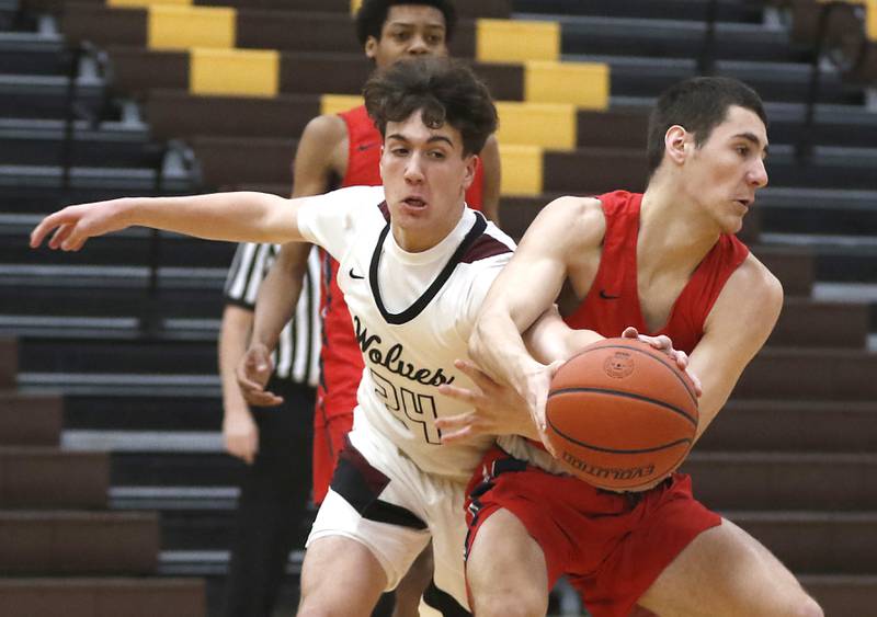 Prairie Ridge's Ben Gablenz tries to knock the ball away from South Elgin’s Derek Clar \during a Hinkle Holiday Classic basketball game Tuesday, Dec. 27, 2022, at Jacobs High School in Algonquin.