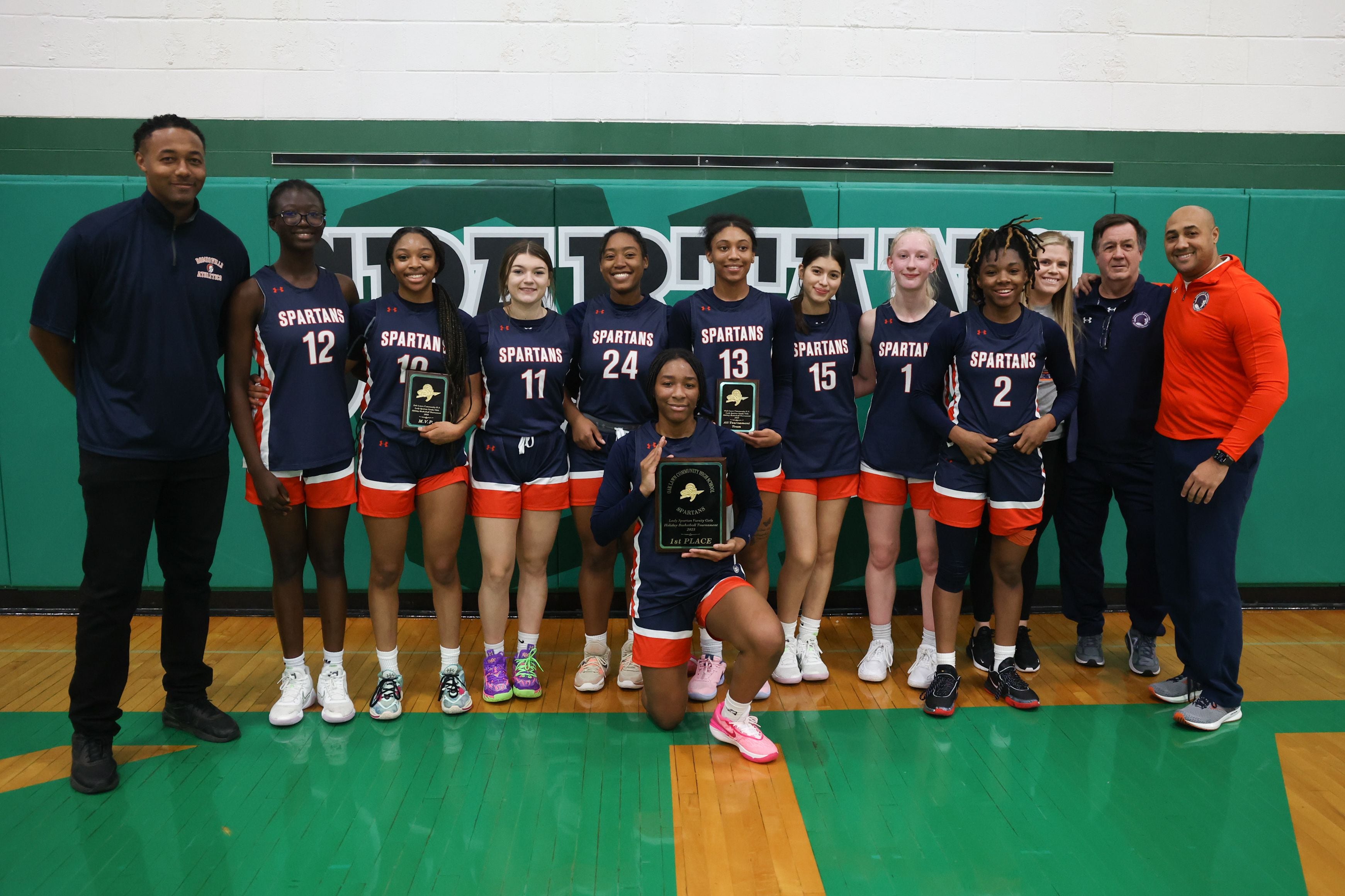 Romeoville poses with the championship plaque after their 46-35 win over Lockport in the Oak Lawn Holiday Tournament championship on Saturday, Dec.16th. Jaylen Zachary (10) was named tournament MVP and Jadea Johnson (13) made All-Tournament Team.
