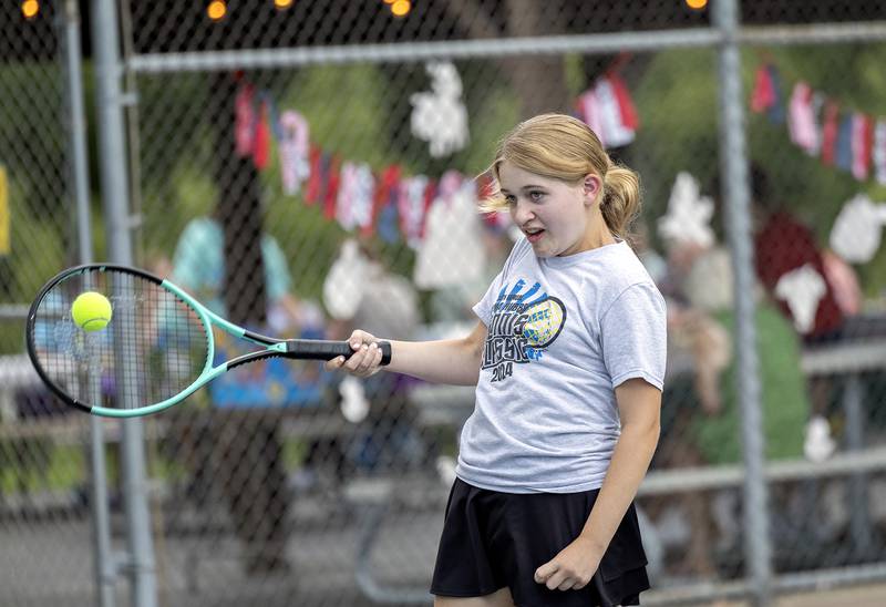 Ella Dobie, 12, returns a shot Friday, July 25, 2025, while playing tennis with her family during a family fun day at the end of the Emma Hubbs Tennis Classic in Dixon.