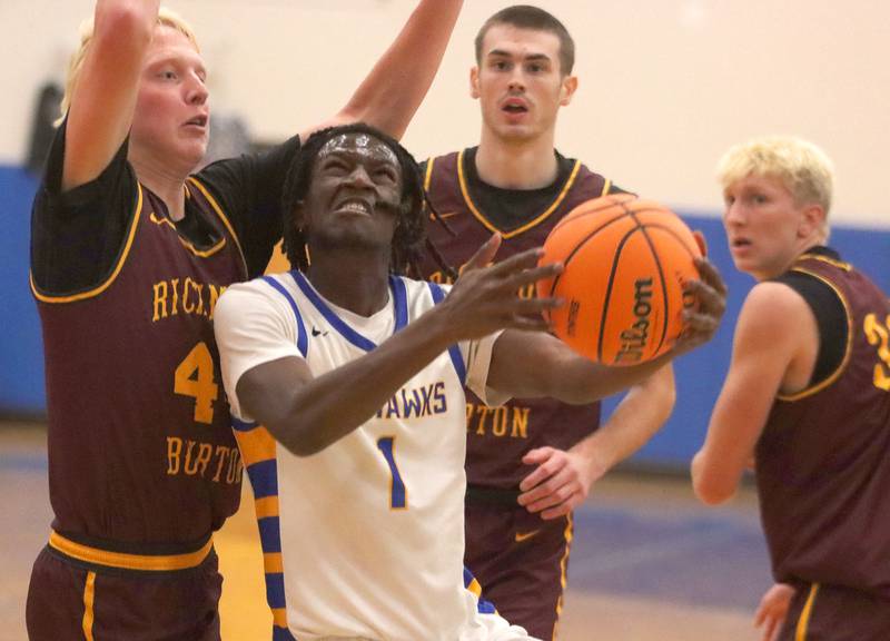 Johnsburg’s Jarrel Albea gets past Richmond-Burton’s Ray Hannemann, left, in varsity boys basketball onTuesday, Dec. 9, 2025, at Johnsburg High School in Johnsburg.