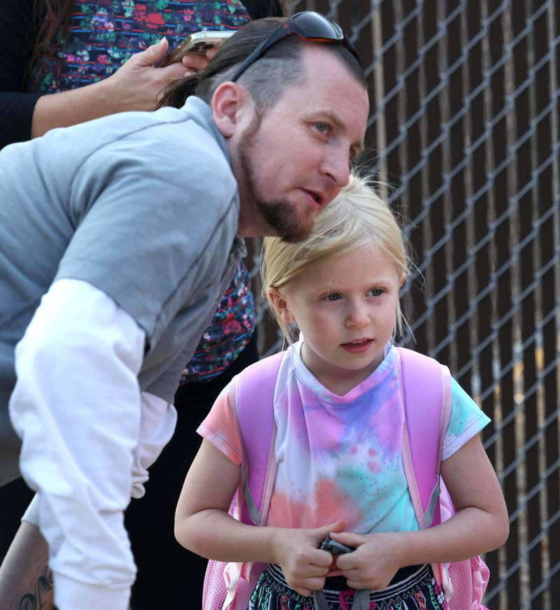 Natalyia Lord, a first grader at Lincoln Elementary School, gets some last minute advice from her dad Bill as she arrives for her first day of classes Wednesday, Aug. 14, 2024, at the school in DeKalb.