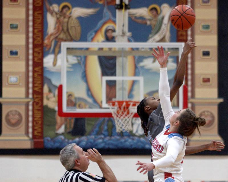 Marian Central’s  Lucy Iden and Rockford Guilford’s Zariah Burnett tip off to begin play in varsity girls basketball Saturday at Landers Pavilion on the campus of Marian Central High School in Woodstock.