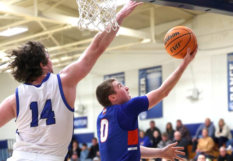Genoa-Kingston's Nathan Kleba gets up a shot in front of Hinckley-Big Rock's Martin Ledbetter during their game Tuesday, Jan. 7, 2025, at Hinckley-Big Rock High School.