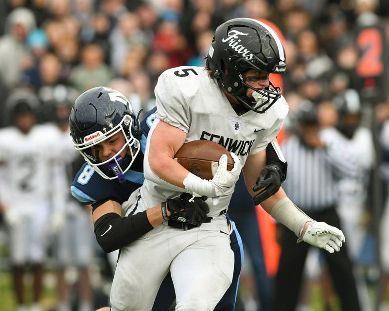 Nazareth Academy's Henry Sakalas (8) tackles Fenwick's ball carrier Mike Muprhy (5) during the 6A semifinals game on Saturday Nov. 22, 2025, held at Nazareth Academy High School in La Grange Park.