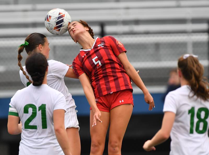 Hinsdale Central’s Emily DiTomasso (5) heads the ball away from three York players during the Class 3A Downers Grove South Sectional final game on May 30, 2025 at Downers Grove South High School in Downers Grove .