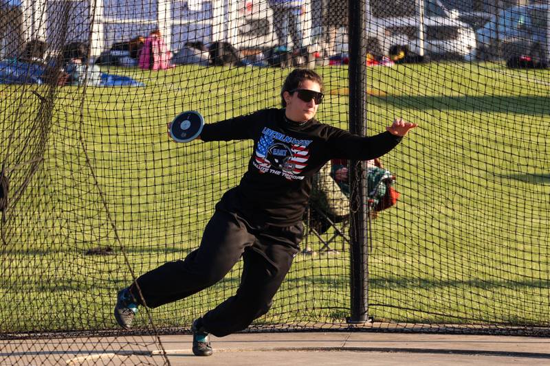 Lincoln-Way East's Angelina Tadros throws discus during the IHSA Class 3A Chicago Heights Girls Track and Field Sectional at Bloom High School on Wednesday, May 13, 2026. Grant took third place and qualified for state with a distance of 37.66 meters.