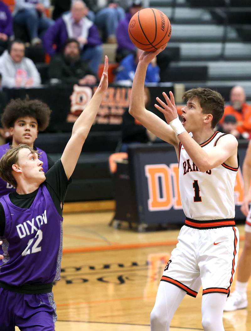 DeKalb’s Jackson Kees shoots over Dixon’s Bryce Feit during their game Tuesday, Dec. 12, 2023, at DeKalb High School.