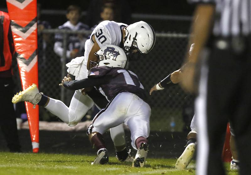 Cary-Grove's Ales Schuppe runs through the tackle of Prairie Ridge's Logan Harlow to score a touchdown after catching a pass during a Fox Valley Conference football game between Prairie Ridge  and Cary-Grove Friday, Sept. 23, 2022, at Prairie Ridge High School in Crystal Lake.
