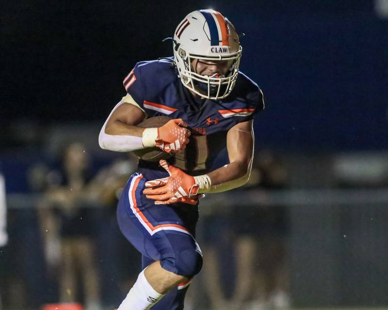 Oswego's Teddy Manikas (11) runs into the endzone to score  touchdown during a football game between Neuqua Valley and Oswego on Friday, Aug. 30, 2024 in Oswego. Gary E Duncan Sr for Shaw