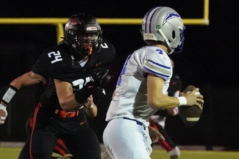 Sandwich’s Dom Rome (24) rushes Woodstock's Caden Thompson (4) during a football game at Sandwich High School on Friday, Oct. 11, 2024.