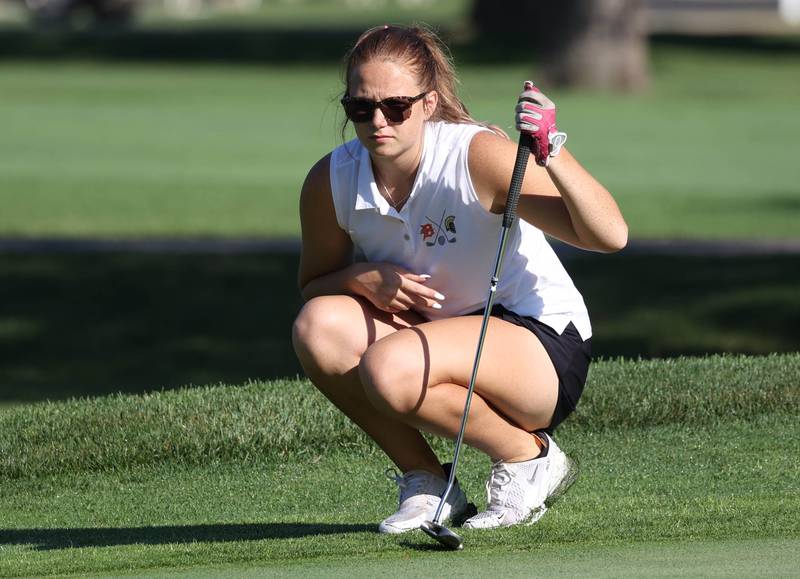 DeKalb-Sycamore co-op’s Taya Johnson lines up her putt on the second green Tuesday, Sept. 23, 2025, during the Interstate 8 girls golf meet at the Sycamore Golf Club.