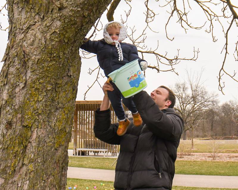 Kevin pashakarnis holds up his son Kevin pashakarnis jr., 6, as they find Easter Eggs in the tree at the Easter Egg Hunt event held at Cantigny Park on Sunday March 24, 2024.