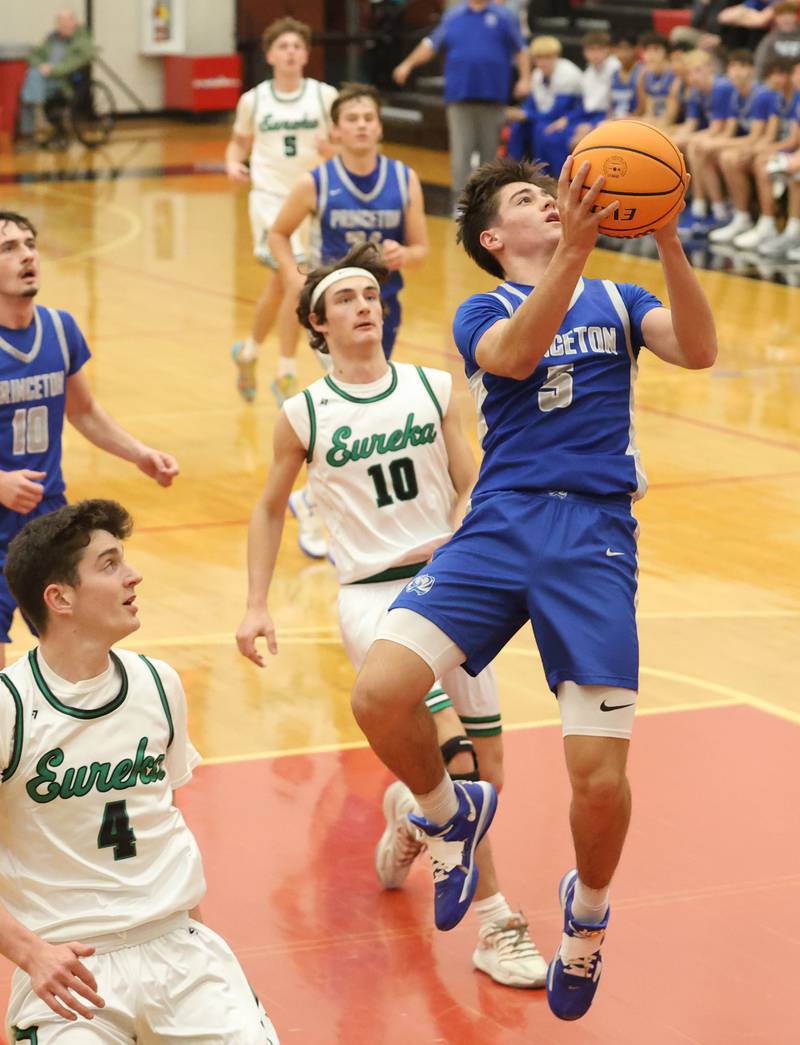 Princeton's Jack Oester runs in the lane to score against Eureka's Connell Roth during the Colmone Classic on Thursday, Dec. 11, 2025 at Hall High School.
