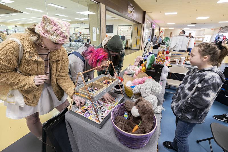 Kristen Bushman (left), Shae Marks and Ro Urbaniak look over Monroe Wicklund’s, 9, booth Saturday, March 4, 2023 at the Northland Mall’s arts and crafts fair. Wicklund of Oregon had a variety of items hand crafted for sale.