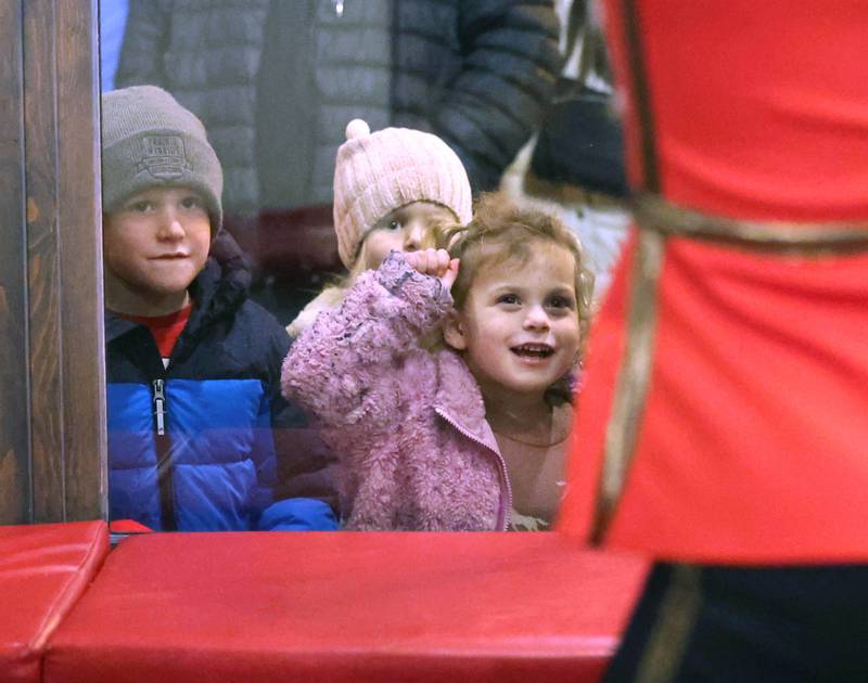Children enjoy watching dancers from the Beth Fowler School of Dance perform the Nutcracker in the window of Pizza. Beer. Whiskey. Friday, Nov. 21, 2025, during Moonlight Magic in downtown Sycamore.