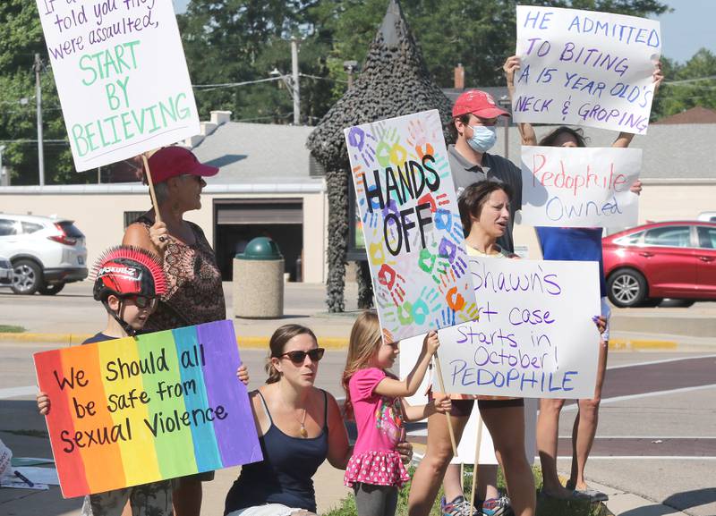 Protesters picket in front of Shawn's Coffee Shop in Sycamore Friday to inform the public of allegations that the owner, Shawn Thrower, committed misdemeanor battery against a 15-year-old employee. Thrower allegedly bit and inappropriately touched the employee.