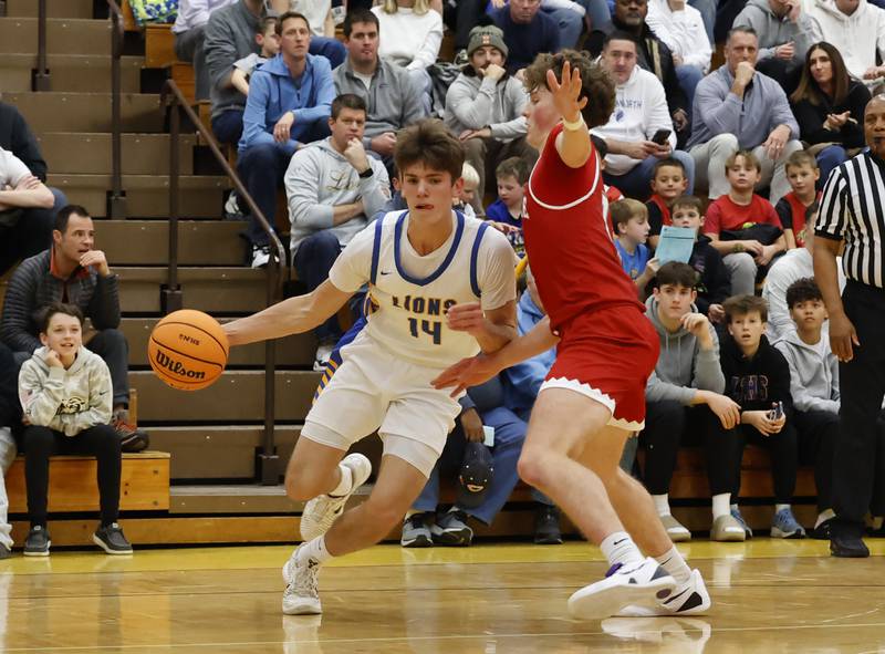 Lyons Township's Grant Smith (14) drives to the basket during a varsity basketball game between Hinsdale Central and Lyons Township high schools on Friday, Dec. 12, 2025 in La Grange.