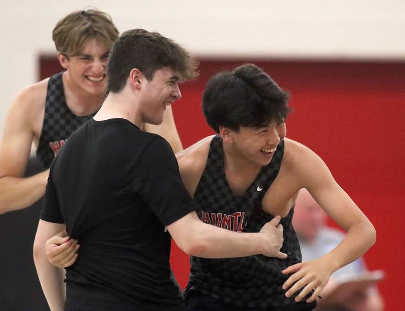 Huntley’s Dorjgotov Shirendev, right, is greeted after clearing the bar in the pole vault  in Fox Valley Conference boys track and field meet action at Huntley High School in Huntley on Thursday, May 15, 2025.