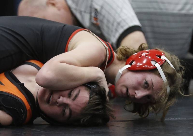 Huntley’s Amanda Wiktor pins McHenry’s Bri Duran during the 125-pound match of a Fox Valley Conference girls wrestling match Thursday, Jan. 11, 2024, at McHenry High School.