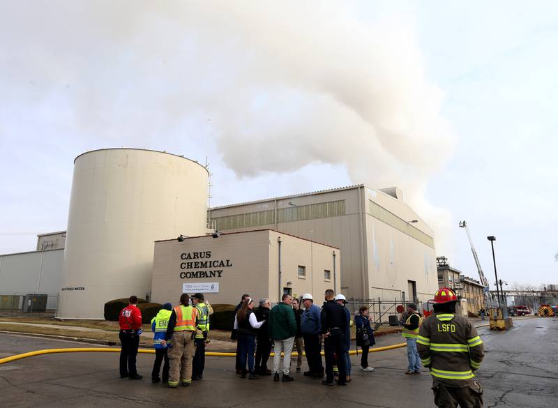 Emergency personnel meets with Carus employees outside the Carus Chemical Company on Wednesday, Jan. 11, 2023 in La Salle.
