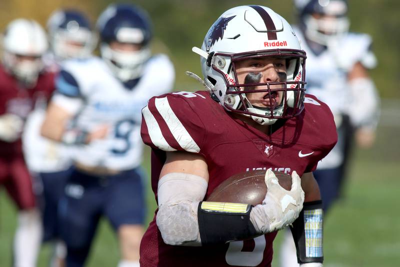 Prairie Ridge’s Luke Vanderwiel runs the ball against Nazareth in first-round Class 5A playoff football action at Crystal Lake Saturday.