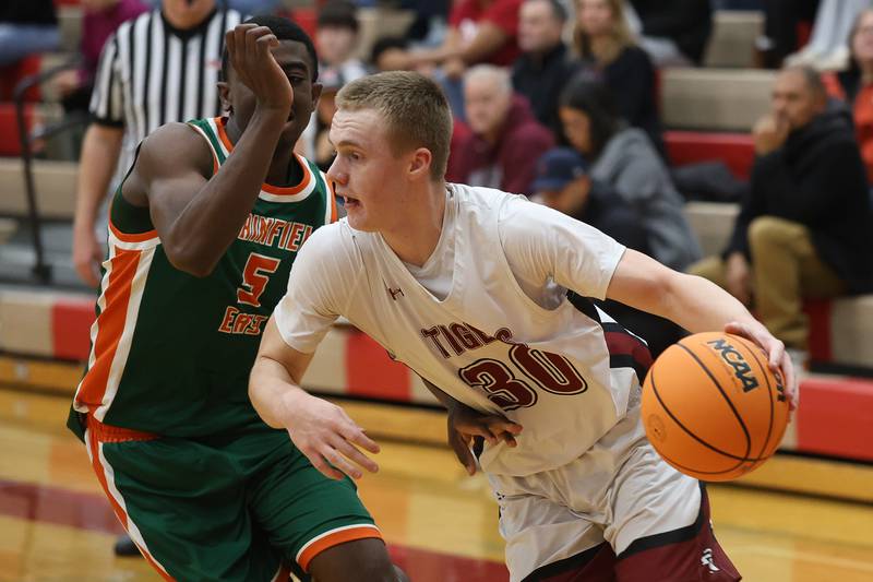 Plainfield North’s Carson Miller drives along the baseline against Plainfield East on Tuesday, Dec. 9, 2025 in Plainfield.