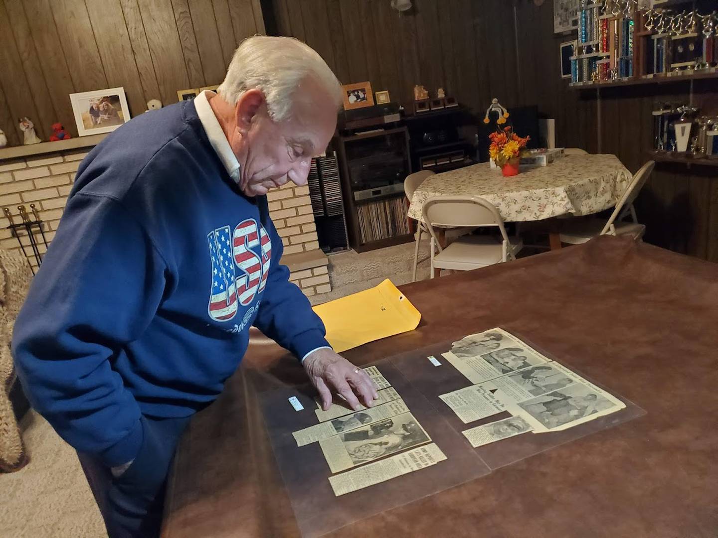 Diana and Robert Ceci of Joliet look through old clippings from The Herald-News that Robert's mother Beverly Ceci had saved and laminated. These clippings are the only record Robert has of his father David Ceci's military service. David Ceci and four of his brothers had all served in the Army during World War II. One was killed in action and another was pronounced missing in action but later came home.