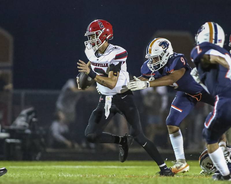 Yorkville's Jack Beetham (2) runs away from the defense during football game between Yorkville at Oswego Friday, Sept 26, 2025 in Oswego.