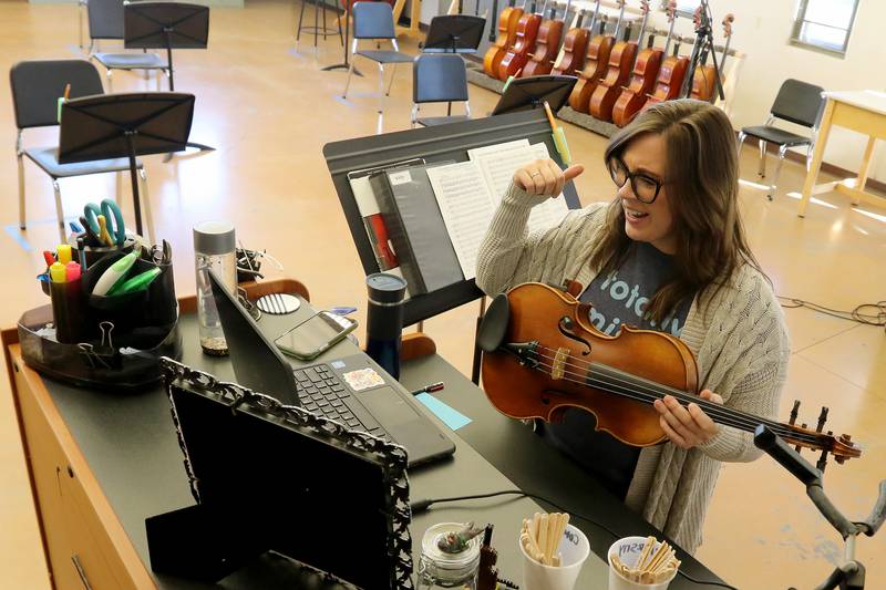 Woodstock North and Northwood Elementary school orchestra teacher Stacie Savittieri conducts an orchestra class with her students over Google Meet on Wednesday, Dec. 9, 2020, at Woodstock North High School in Woodstock.