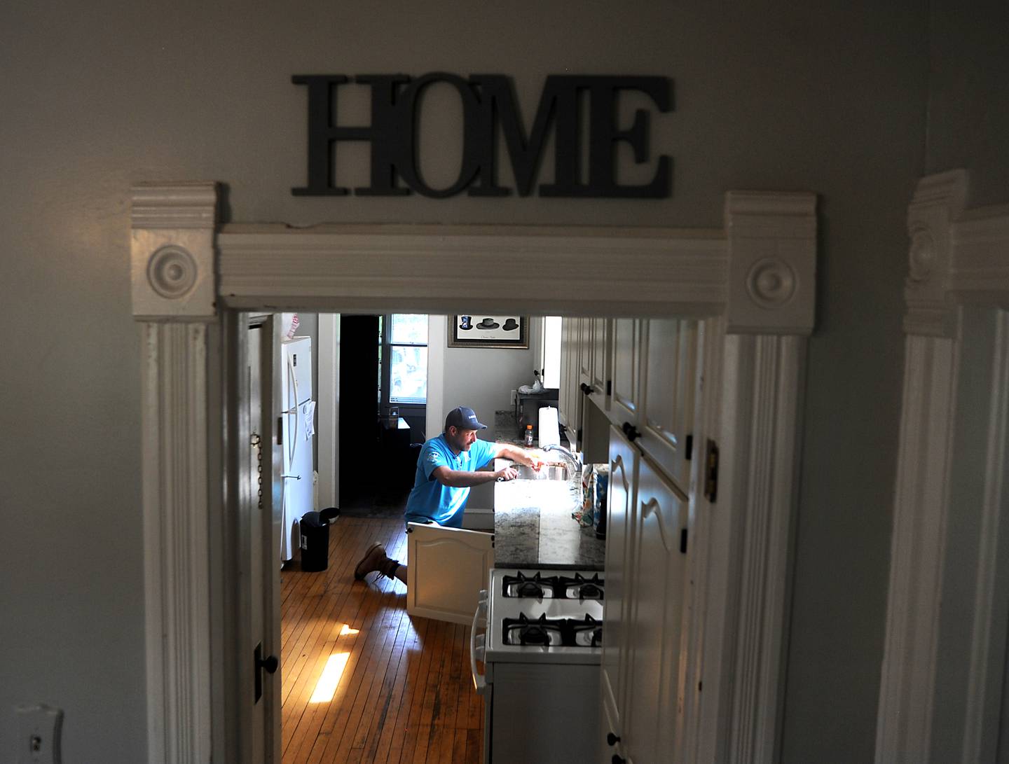 Scott Falasz of Resolute Plumbing, a trade partner of Lennar, does a final check of a facet he installed Friday, May 13, 2022, in Kids in Need of McHenry County home at 55 E. Crystal Lake Ave. in Crystal Lake. About 70 employees of Lennar and their trade partners spent the day working on the home which is used for foster kids to interact with their biological parents in a more comfortable and natural setting.