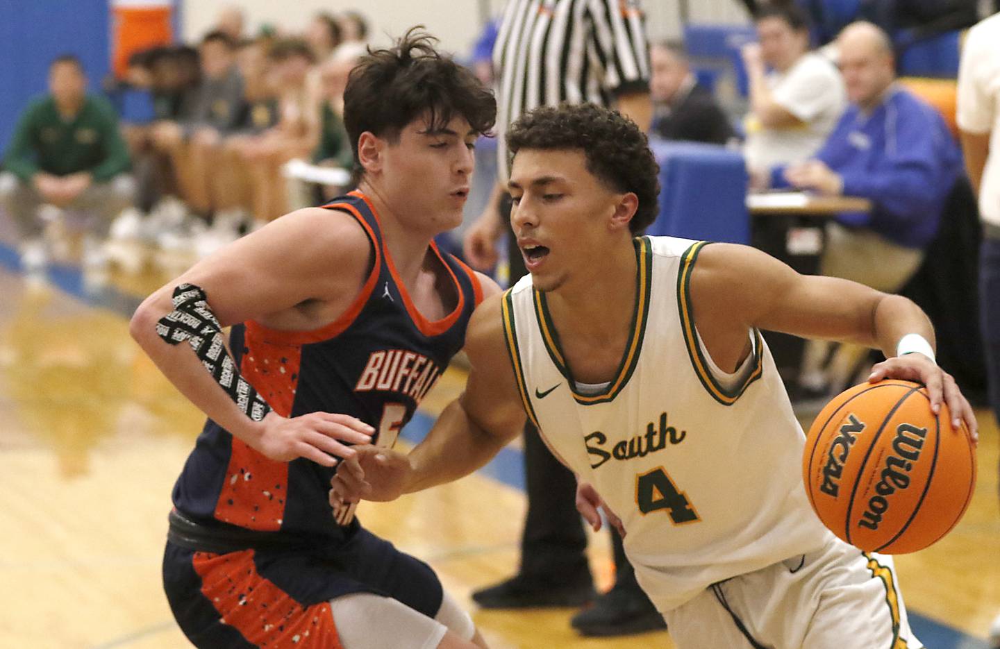 Crystal Lake South's Anthony Demirov (right) drives the baseline against Buffalo Grove's Dylan Ronczkowski during a Johnsburg Thanksgiving Tournament boys basketball game on Monday, Nov. 25, 2024, at Johnsburg High School.