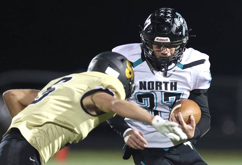 Woodstock North's Kaden Combs runs into Sycamore's Carter York during their game Friday Oct. 7, 2022, at Sycamore High School.