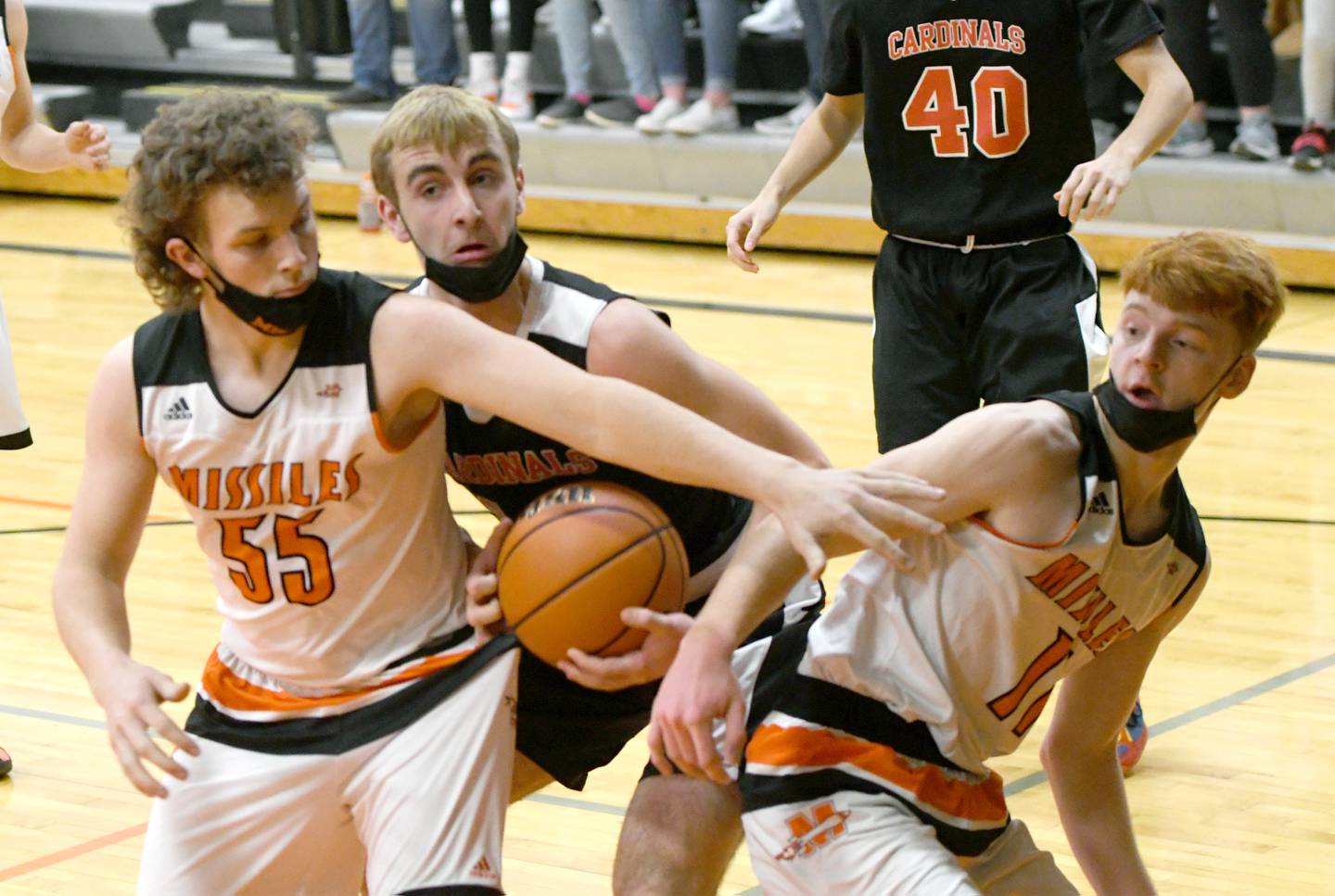 Forreston's Cole Becker (center) battles Milledgeville's Connor Nye (right) and Eric Ebersole during Jan. 4 action in Milledgeville.