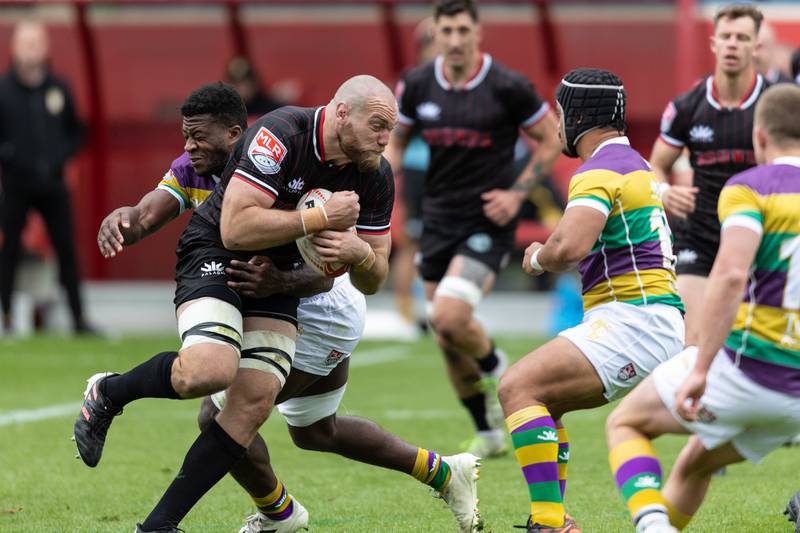 Chicago Hounds' 8-man Luke White, goes into contact with a pair of NOL Gold players, at Seat Geek Stadium in Bridgeview, on Sunday April 23, 2023.