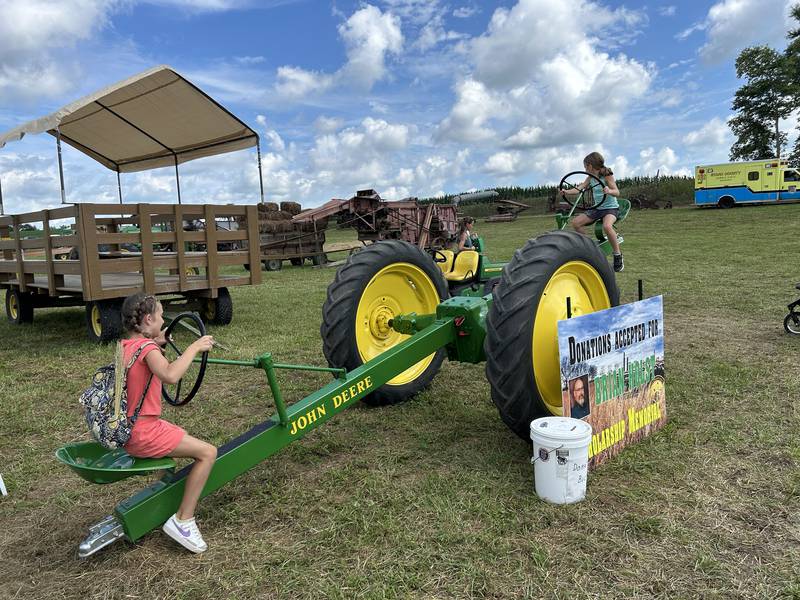 Sawyer Miller, 8, of Bettendorf, Iowa, and Aubrey Romang, 8, of Hillsdale, take a ride on a very special teeter-totter at the Bos Brothers Historical Farm on Friday, July 25, 2025.