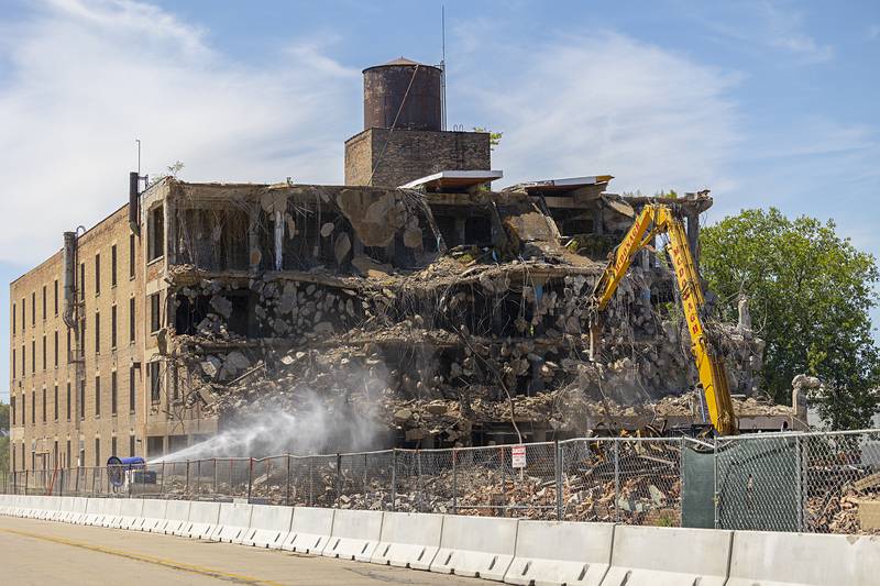 Work crews from McDonagh Demolition continue to tear down the Micro building Wednesday, Aug. 21, 2024, in downtown Rock Falls. Work began on the demolition in early August. Per a contract, the completion must be done in 60 days.