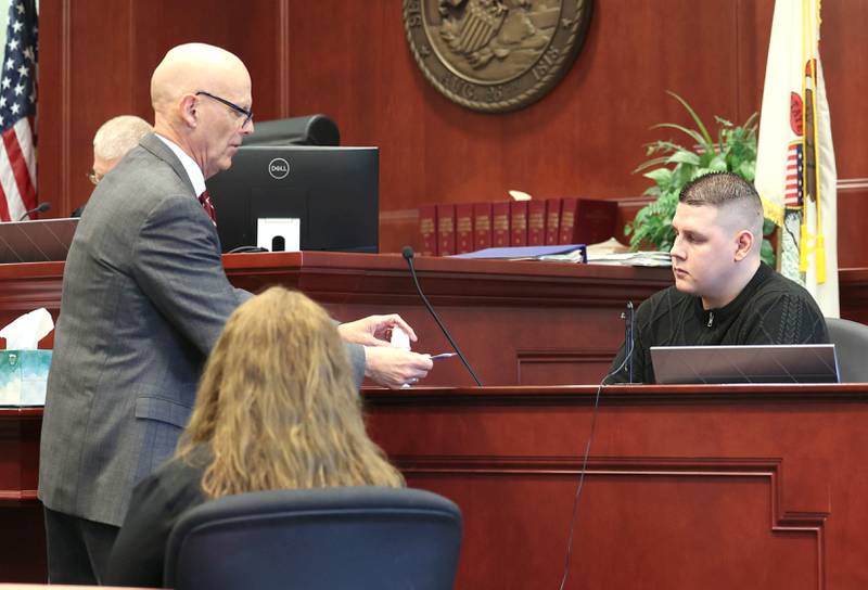 Defense attorney Camic Johnson approaches his client, James Corralejo, to hand him evidence Monday, April 29, 2024, during a hearing at the DeKalb County Courthouse in Sycamore. Prosecutors alleged Corralejo, on release pending charges that he drove drunk and caused a Nov. 5, 2023, crash that killed DeKalb woman Graciela Reza Contreras, 59, tampered with his ankle monitor after it detected alcohol six times in March and April.