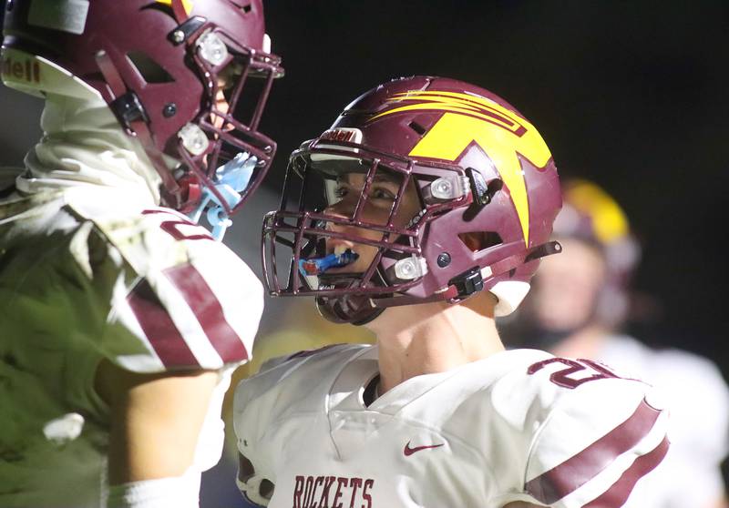 Richmond-Burton’s  Luke Johnson, right, greets teammate Jace Nelson in the end zone after Nelson snagged a touchdown reception against Aurora Central Catholic in IHSA football Class 3A second-round playoff action at Bob Stewart Field on the campus of Aurora Central Catholic High School in Aurora on Friday, November 7, 2025.