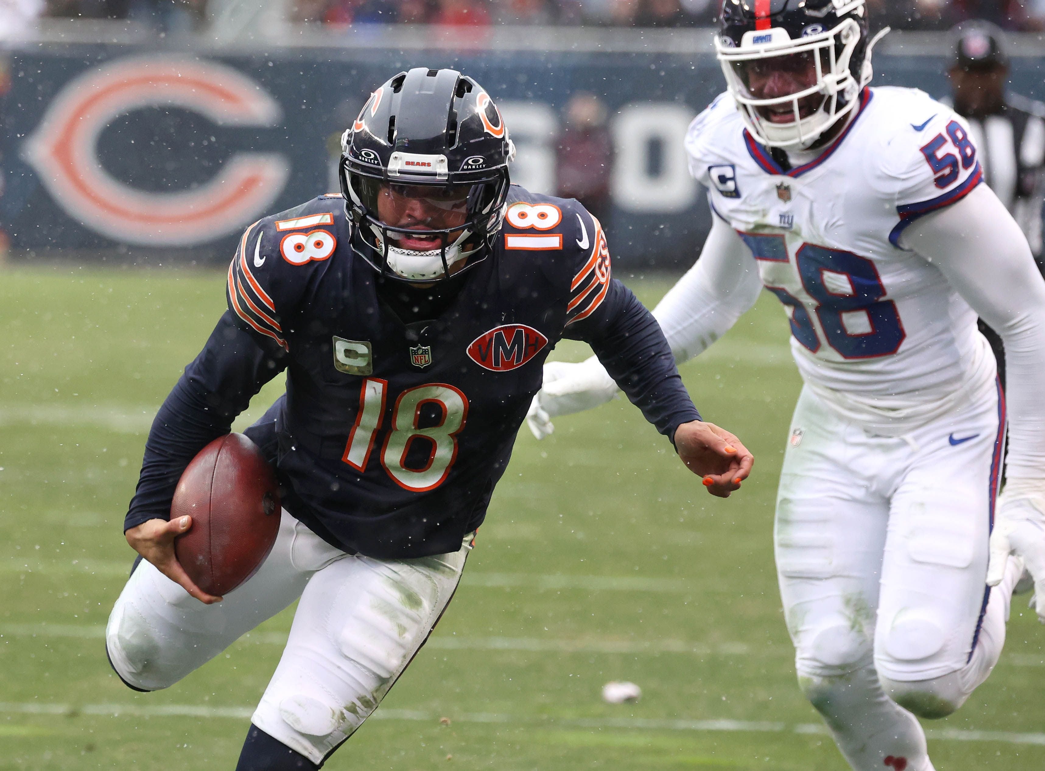 Chicago Bears quarterback Caleb Williams carries the ball down to the one-yard-line ahead of New York Giants linebacker Bobby Okereke Sunday, Nov. 9, 2025, during their game at Soldier Field in Chicago.