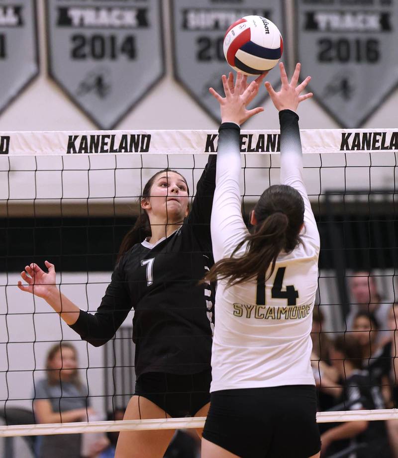 Kaneland's Brielle Gadomski tries to tip the ball over Sycamore's Norah Chami during their match Tuesday, Sept. 30, 2025, at Kaneland High School in Maple Park.