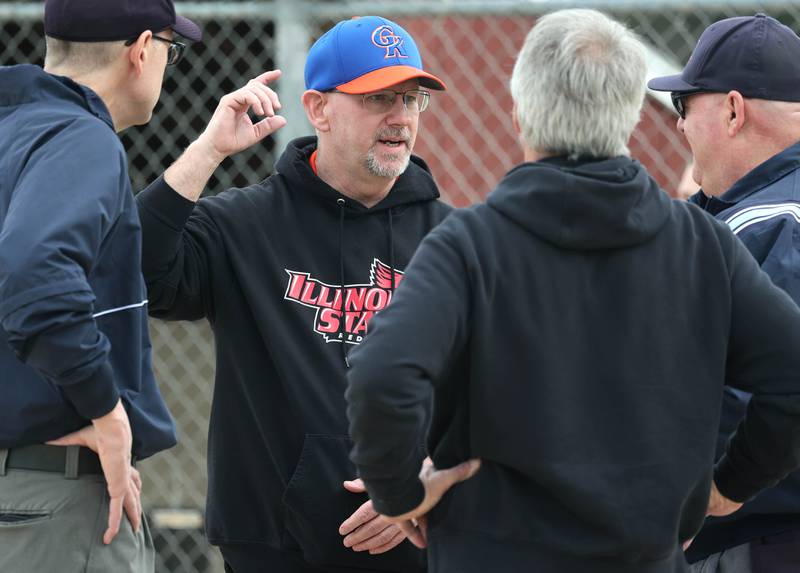 New Genoa-Kingston head softball coach Dave Allen (second from left) meets with the coaches and umpires before their game with Indian Creek Tuesday, March 18, 2025, at Indian Creek High School in Shabbona.